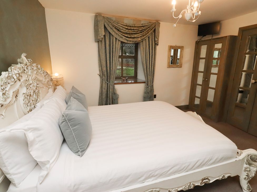 A bedroom with a bed and curtains at The French in 