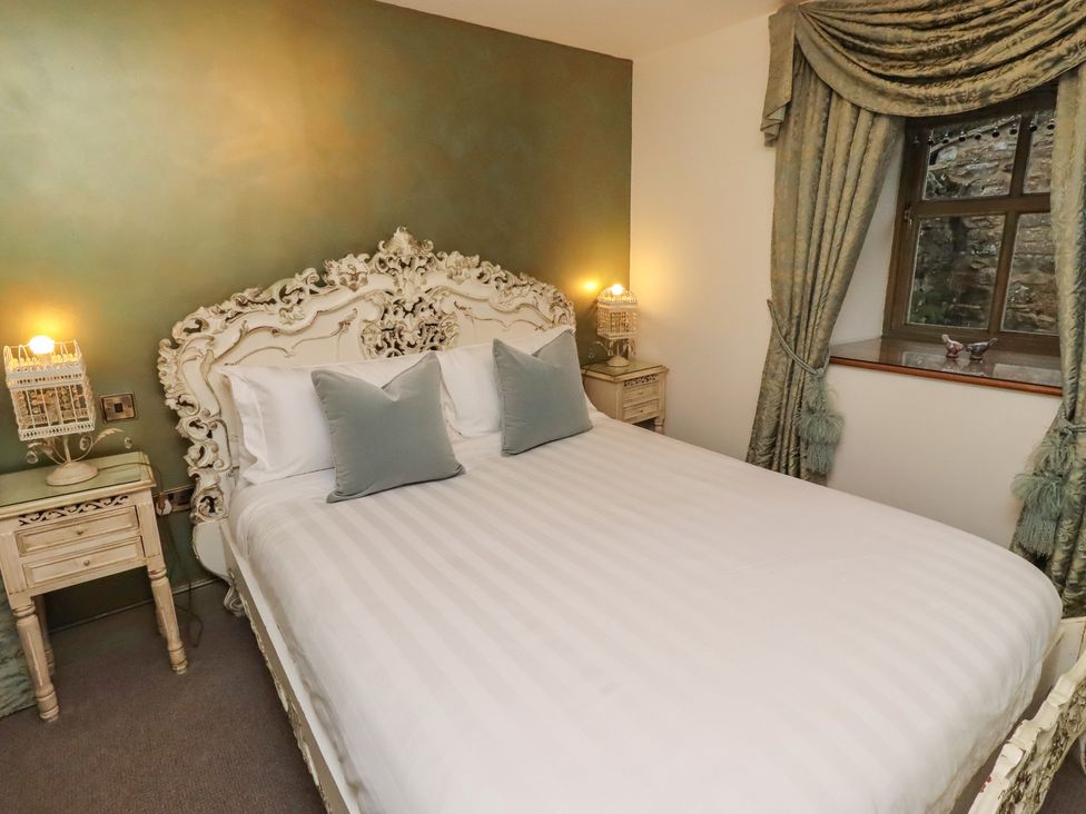 A bedroom with a bed and nightstand at The French in 