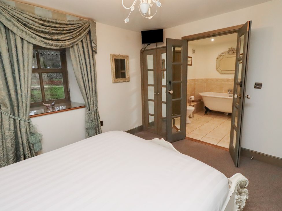 A bedroom with a bed and an adjoining bathroom at The French 