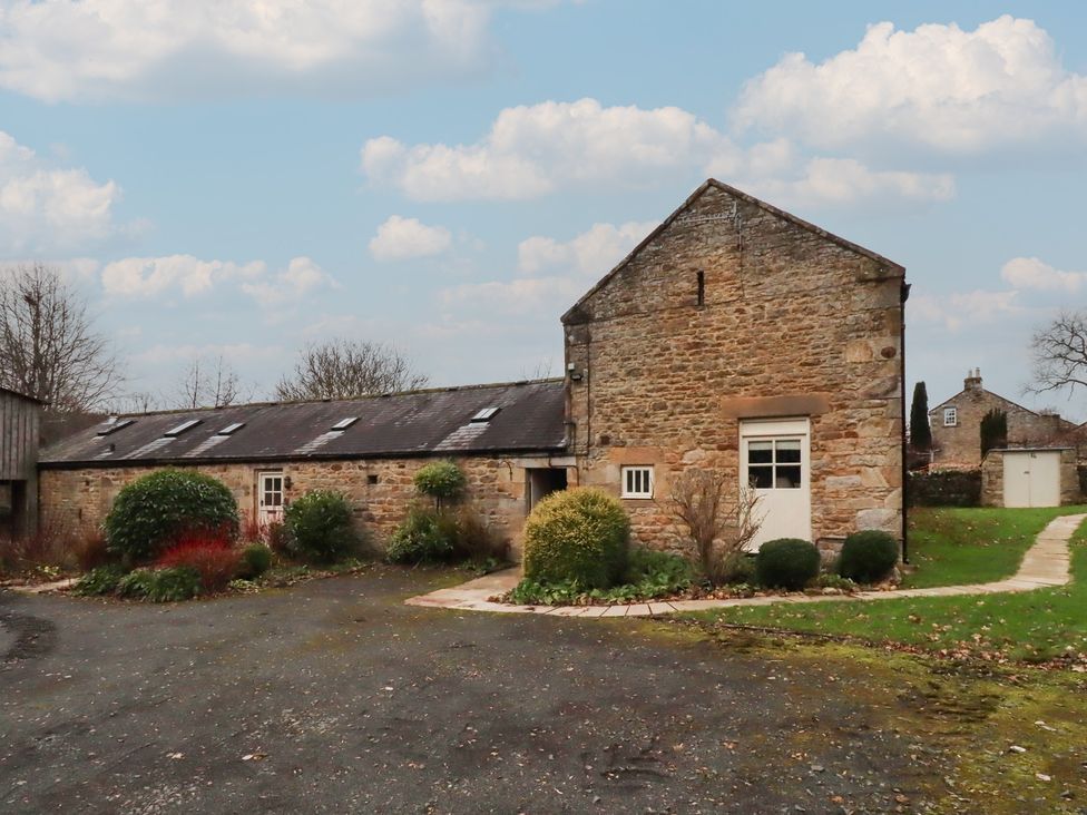 A stone building with garden and pathway at The French 