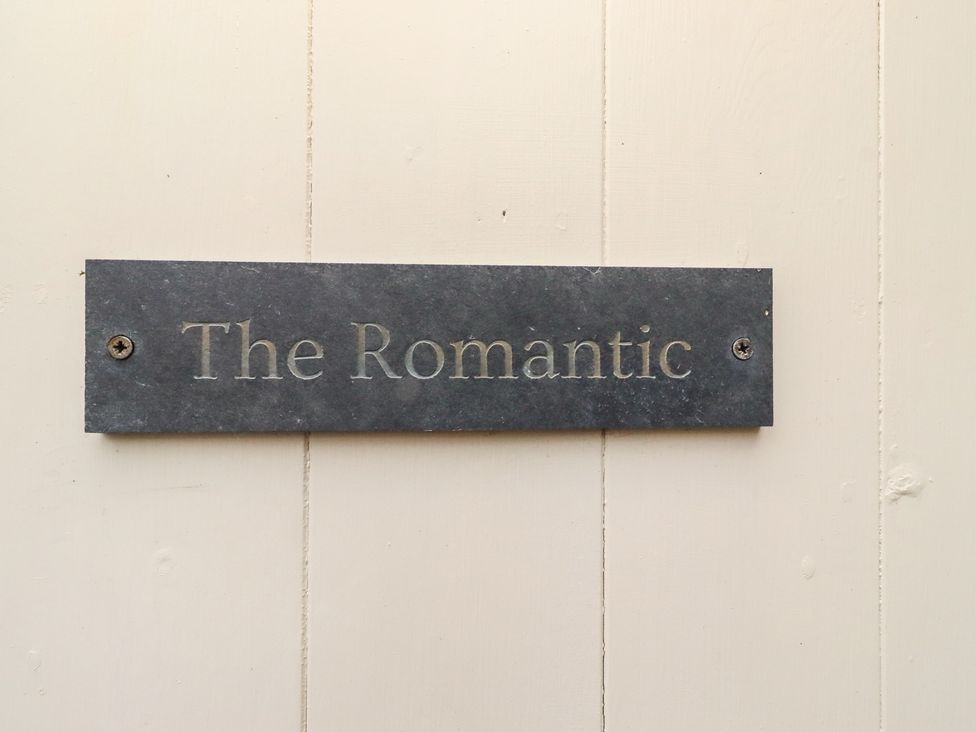 A sign reading The Romantic on a wall at The Medieval Romantic 
