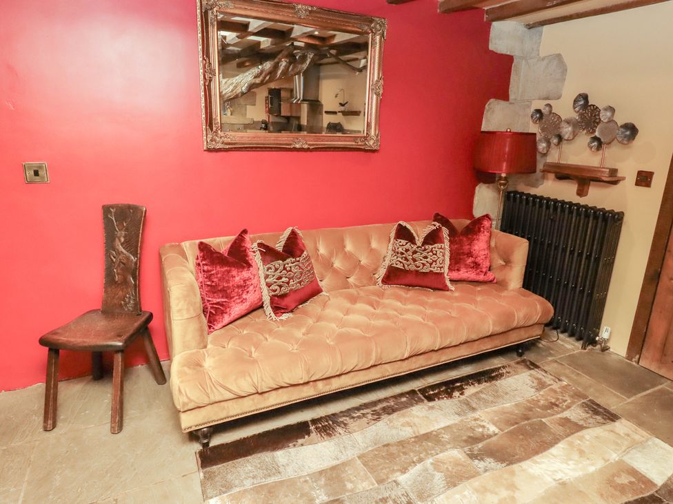 A living room with a sofa and chair at The Medieval Romantic