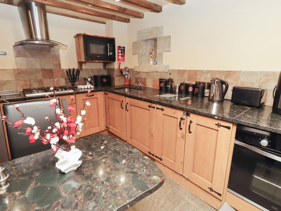 A kitchen with cabinets and appliances at The Medieval Romantic