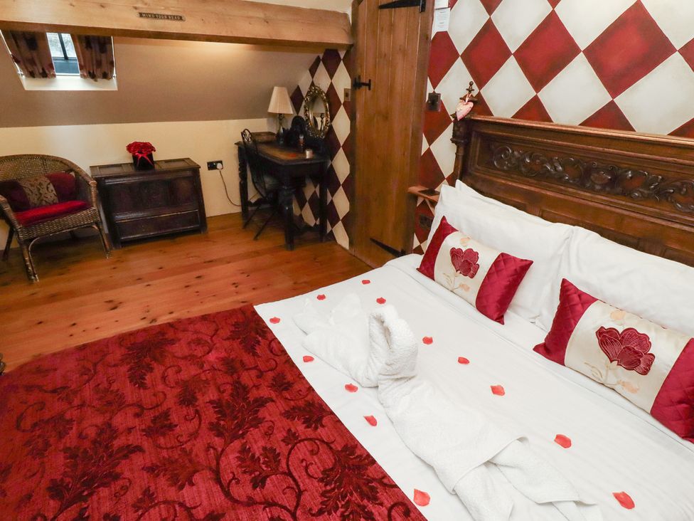 A bedroom with a bed and furniture at The Medieval Romantic 