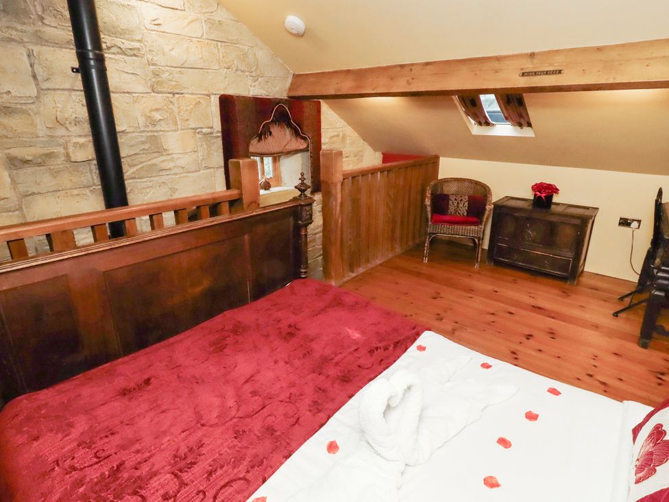 A bedroom with a bed and decor at The Medieval Romantic in 