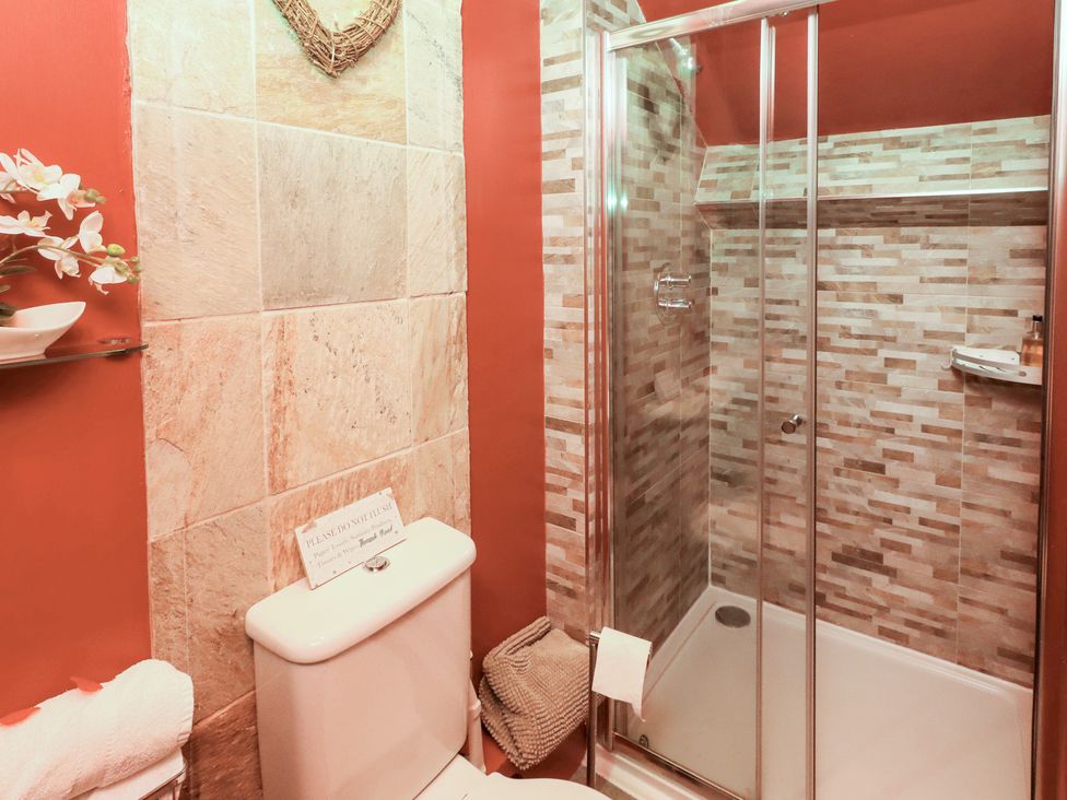 A bathroom with a shower and toilet at The Medieval Romantic