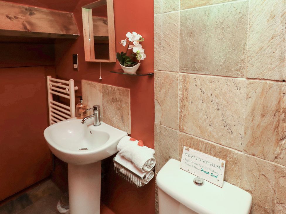A bathroom with a sink and toilet at The Medieval Romantic