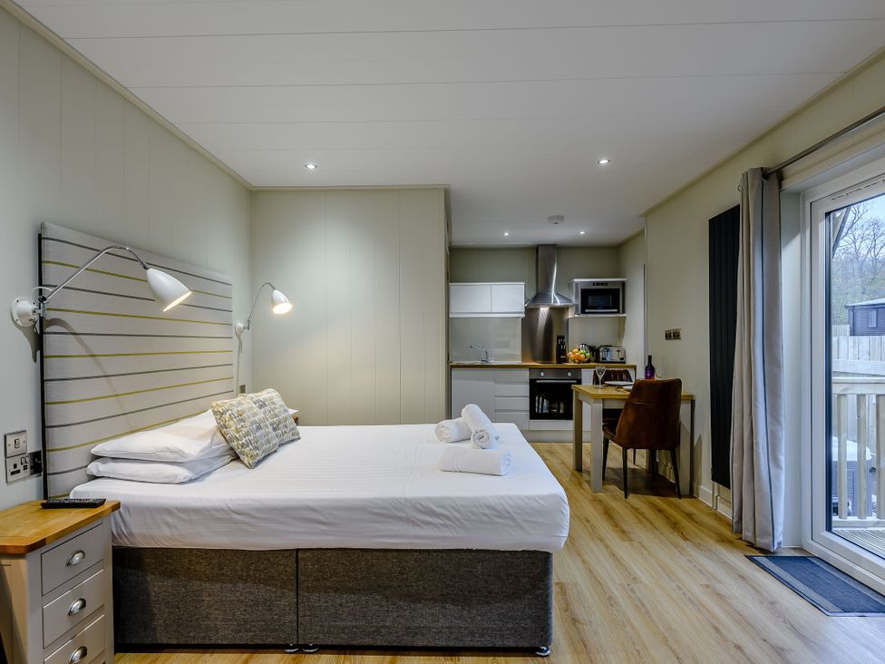 A studio apartment with a bed and kitchenette at Tennyson Spa in Louth