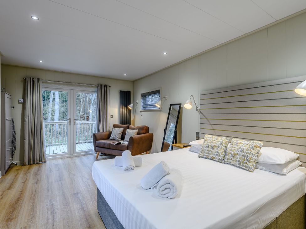 A bedroom with a bed and a sofa at Tennyson Spa (Pet) Louth