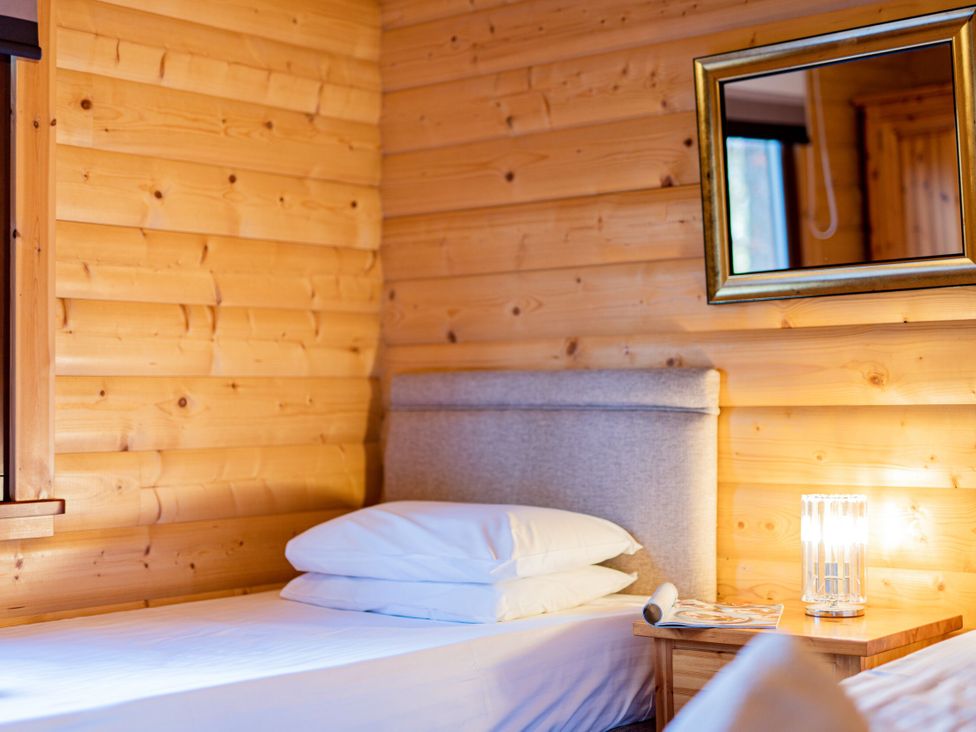 A bedroom with a bed and bedside table at Maple Lodge in Louth