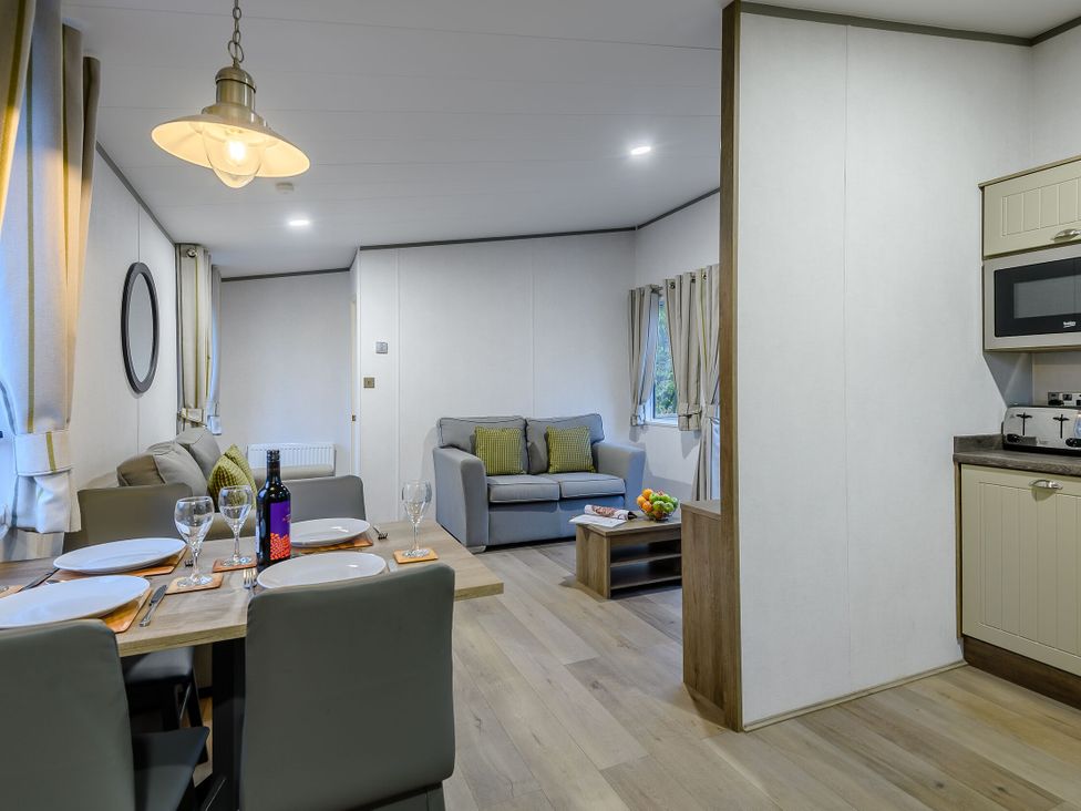 A dining room with a table set for dinner at Anderby Spa (Pet) in Louth