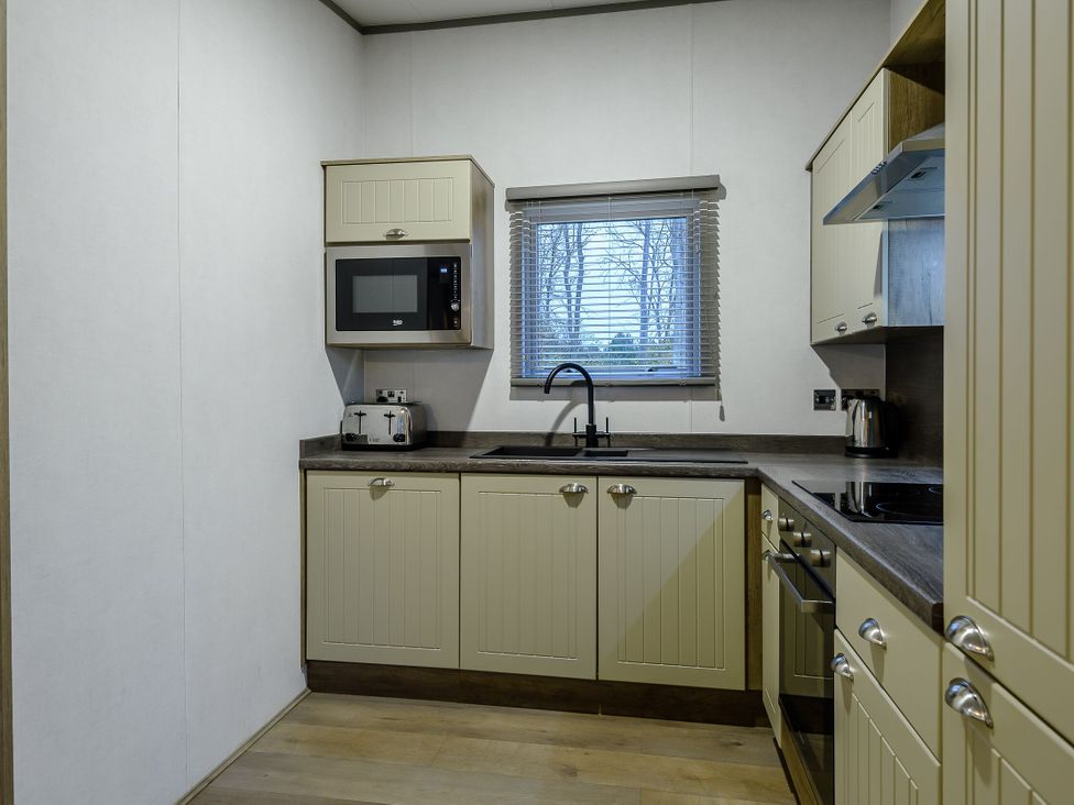 A kitchen with cabinets and appliances at Anderby Spa (Pet) Louth