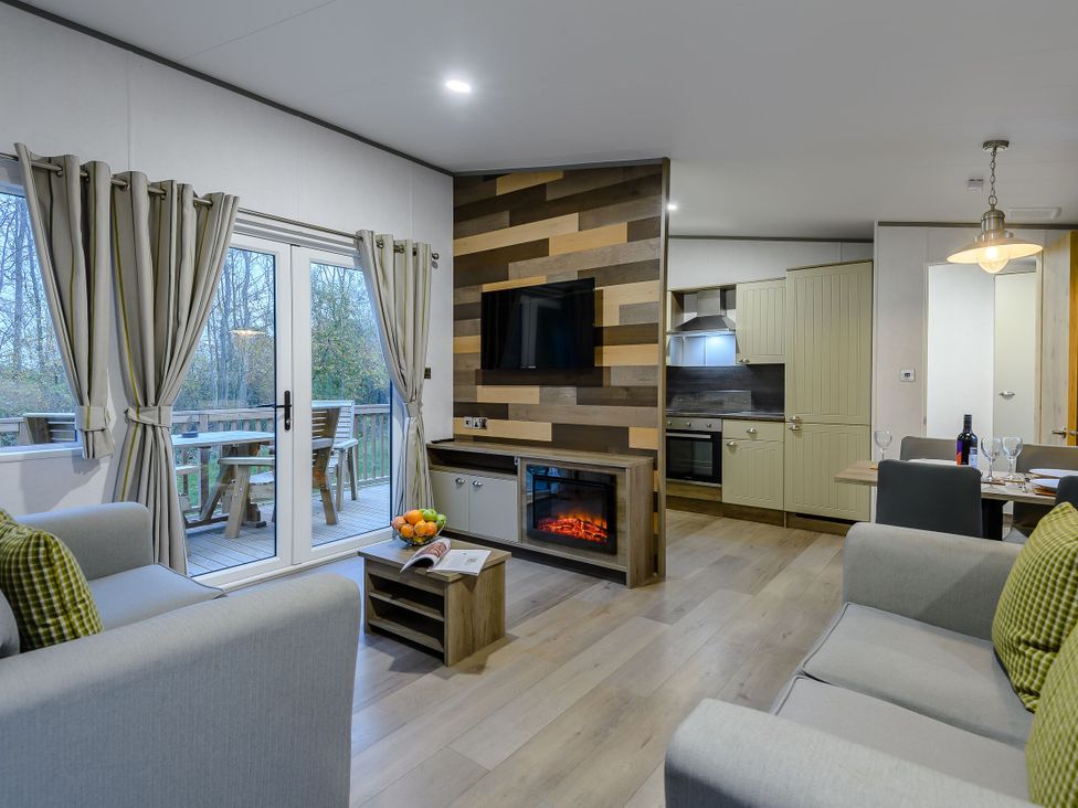 A living room with a television and dining area at Anderby Spa (Pet) Louth