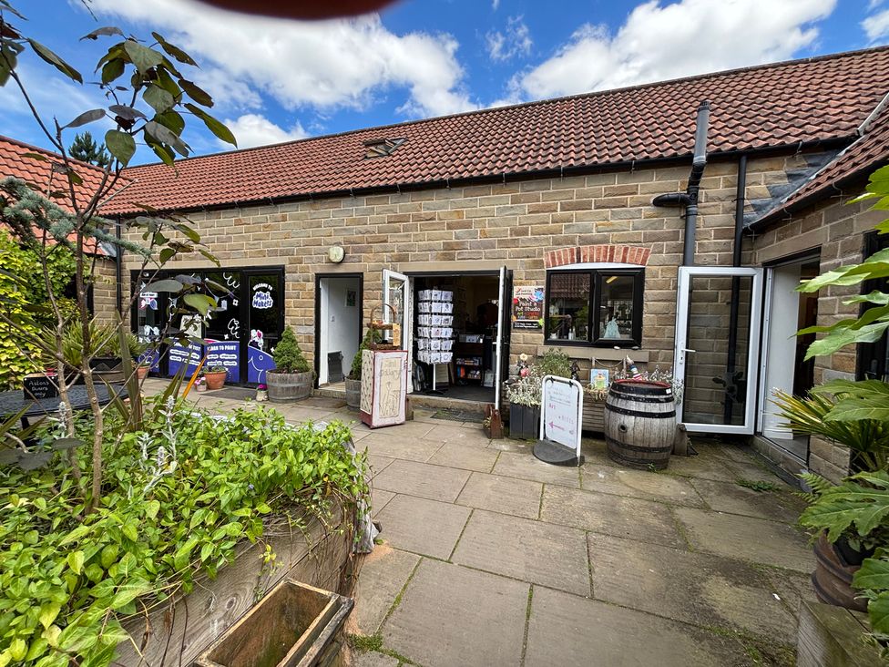 An outdoor area with a building entrance and plants at Kingfisher Hut in Swallownest near Sheffield