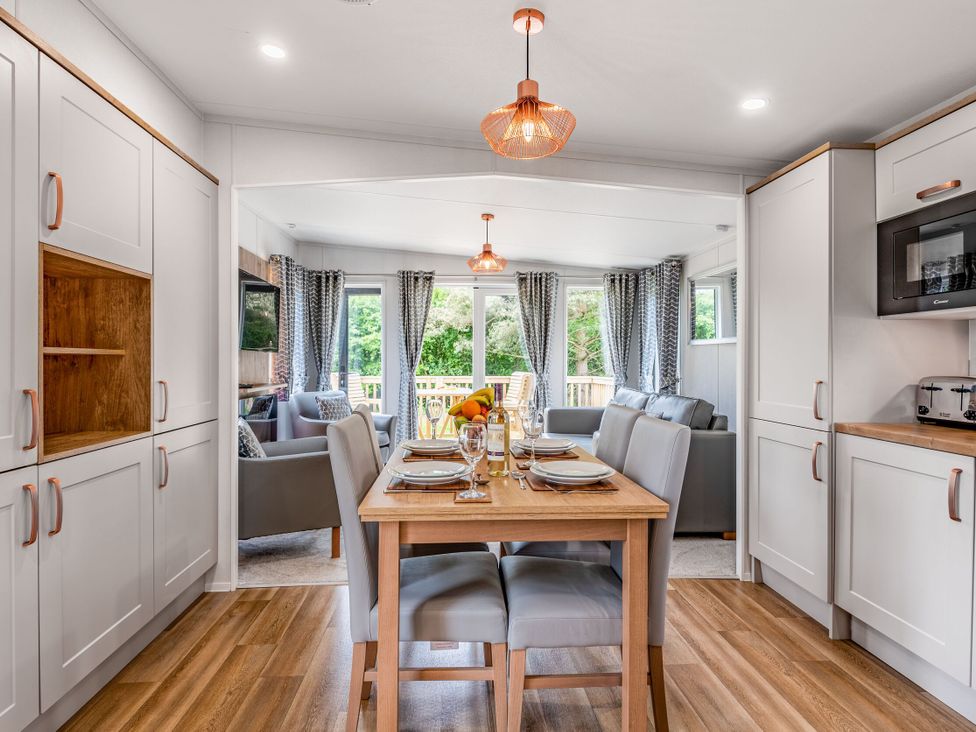 A kitchen with a dining table and chairs at Caistor Spa in Louth