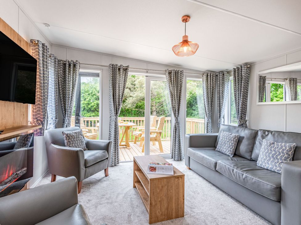 A living room with a sofa and television at Caistor Spa in Louth