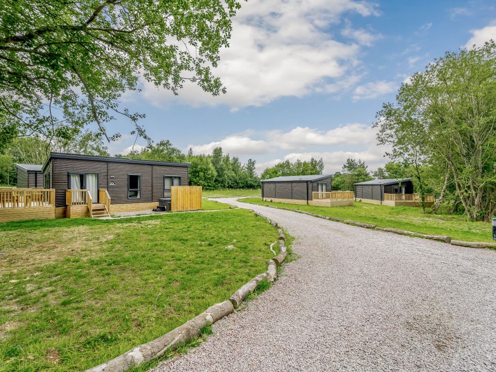 Cabins with a gravel path near trees at Horncastle Plus in Louth