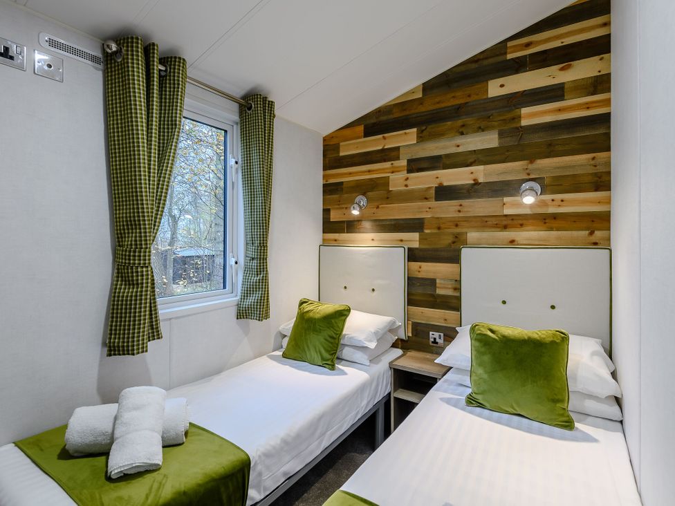 A bedroom with two beds and a window at Alford Spa in Louth