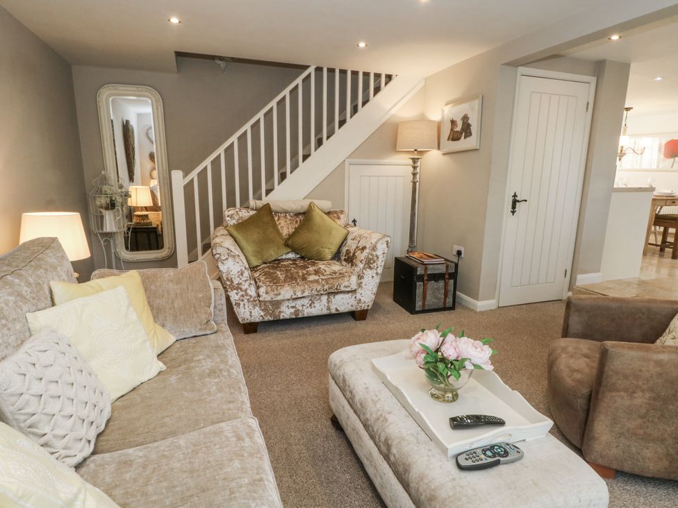 A living room with a sofa and coffee table at Curlew Cottage, Lower Peover, Cheshire