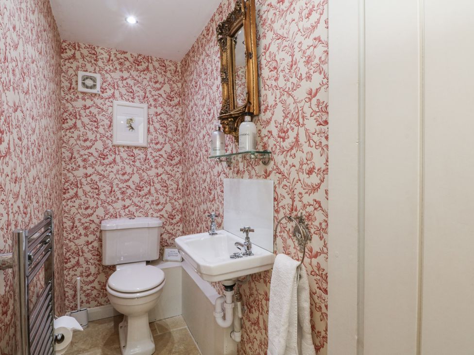 A bathroom with a sink and toilet at Curlew Cottage in Lower Peover, Cheshire
