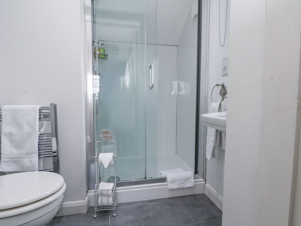 A bathroom with a shower and sink at Curlew Cottage Lower Peover Cheshire