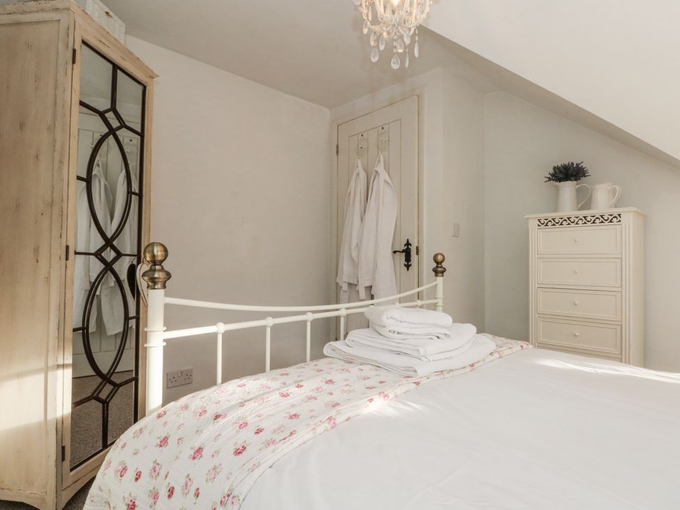 A bedroom with a bed and dressing table at Curlew Cottage in Lower Peover, Cheshire