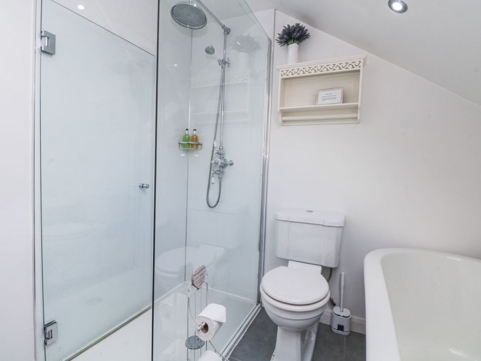 A bathroom with a shower and toilet at Curlew Cottage Lower Peover Cheshire