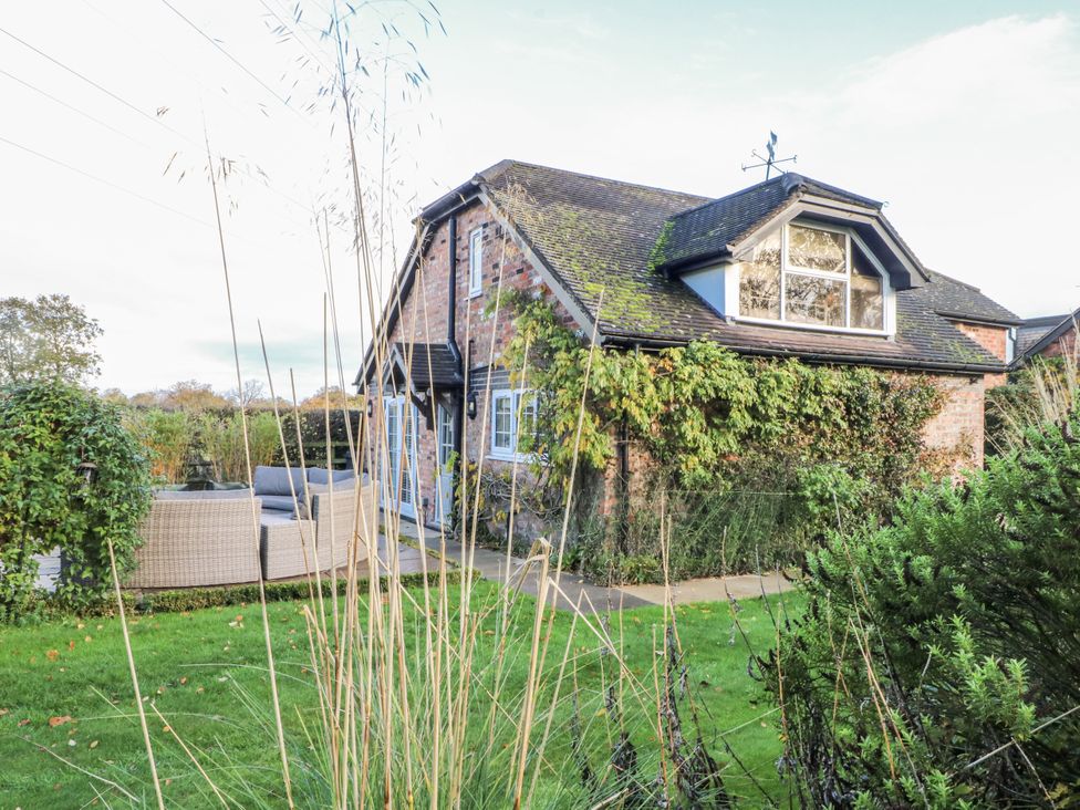 A house with garden furniture at Curlew Cottage in Lower Peover, Cheshire
