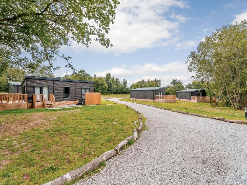 An outdoor view of cabins along a gravel pathway at Horncastle Spa Plus, Louth