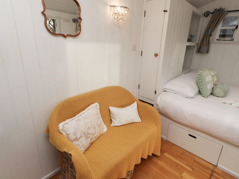 A bedroom with a sofa and a bed at Meadows in Hexham