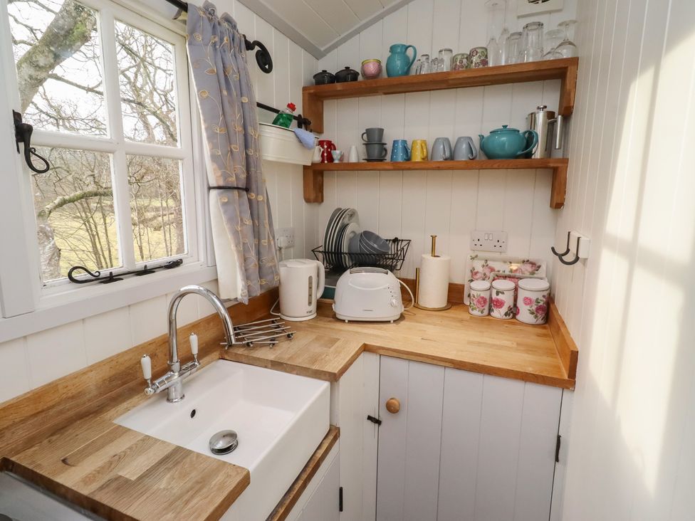 A kitchen with a sink and shelves at Meadows in Hexham