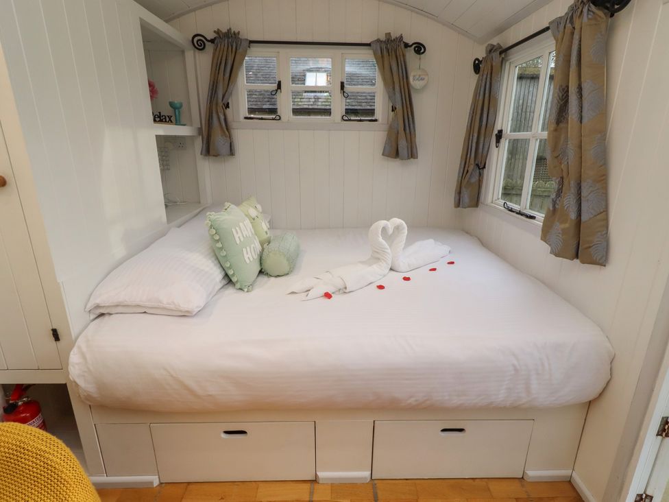 A bedroom with a bed and decorative pillows at Meadows in Hexham