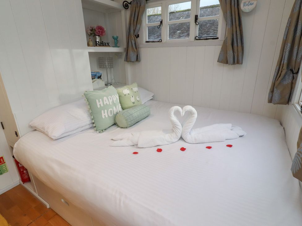 A bed with pillows and towels arranged in swan shape at Meadows in Hexham