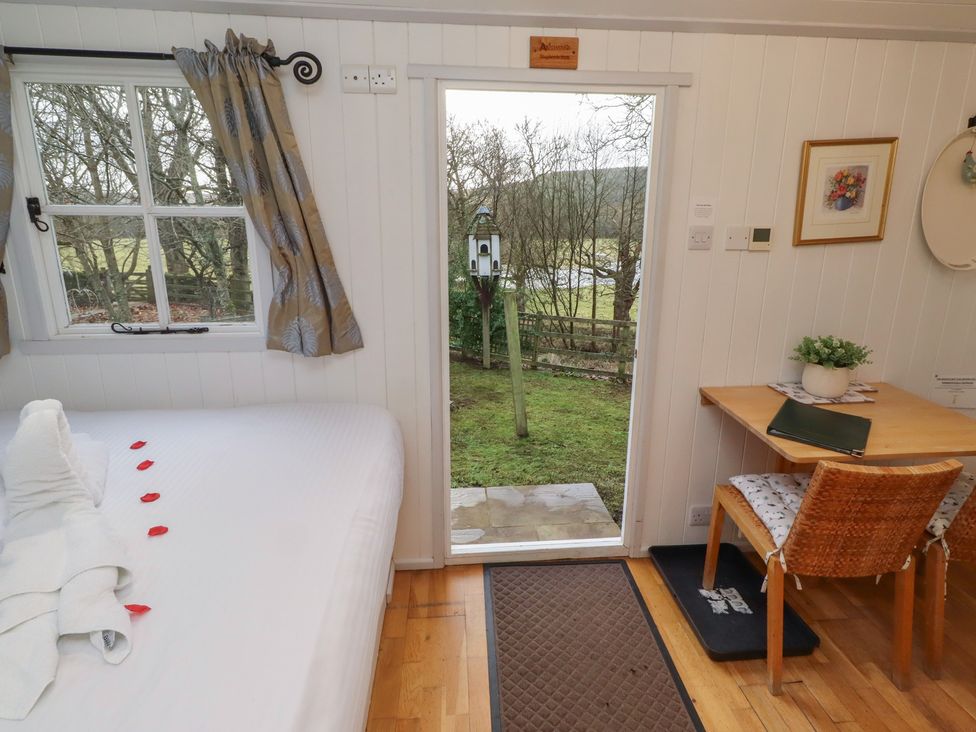 A bedroom with a door leading outside at Meadows in Hexham