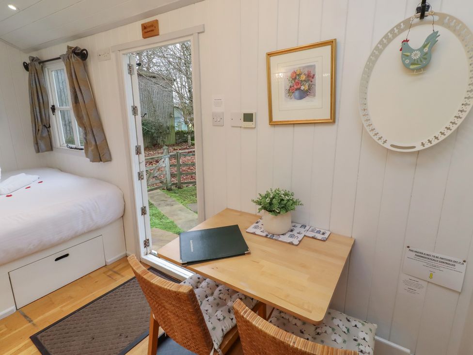 A bedroom with a bed and dining area at Meadows in Hexham