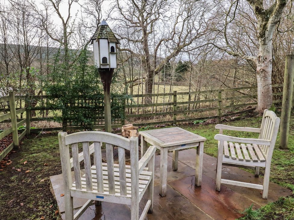A garden area with chairs and a birdhouse at Meadows in Hexham