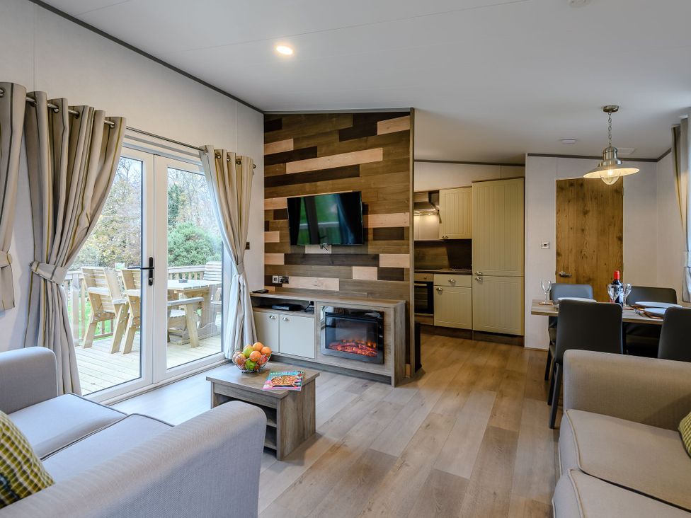 A living room with a sofa, television, and fruit bowl at The Kinder Spa in Louth