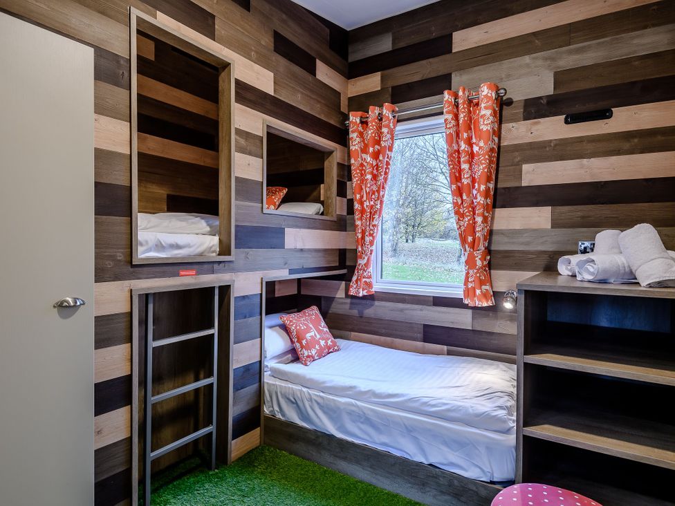 A bedroom with a bunk bed and shelf at The Kinder Spa in Louth