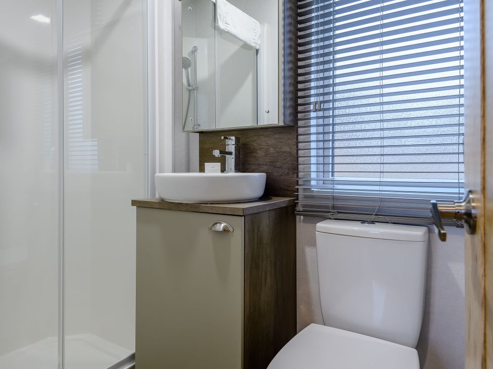 A bathroom with a shower a sink and a toilet at The Kinder Spa in Louth