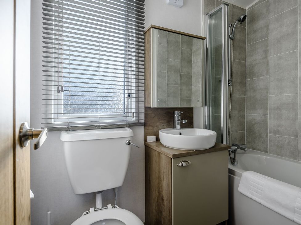 A bathroom with a toilet, sink, shower and bathtub at The Kinder Spa (Pet) Louth