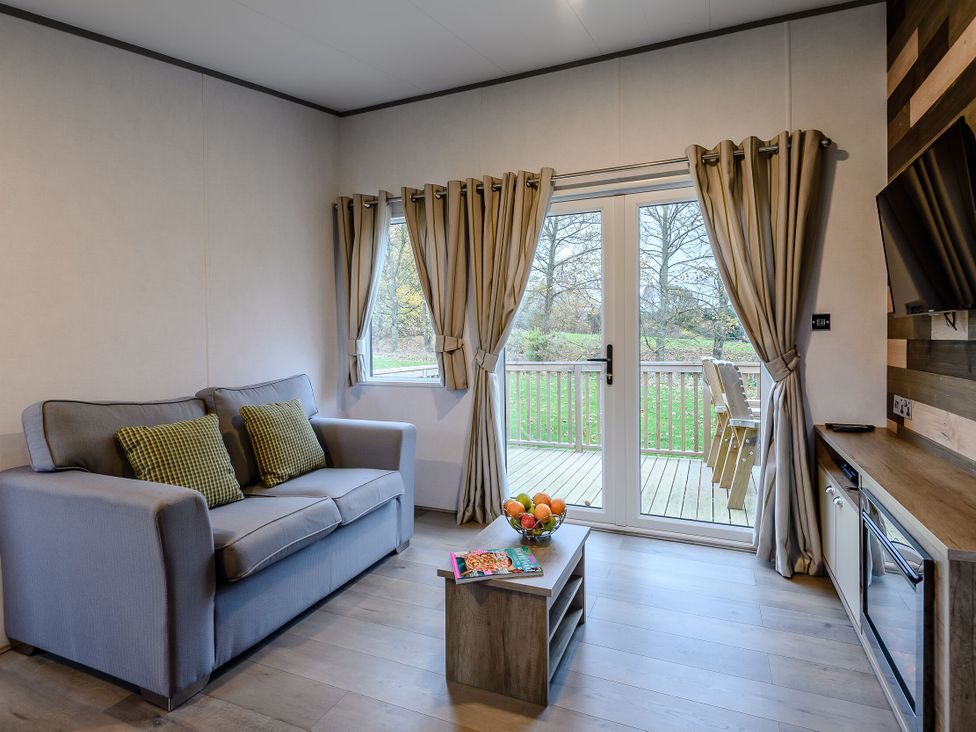 A living room with a sofa and table at The Kinder Spa (Pet) Louth