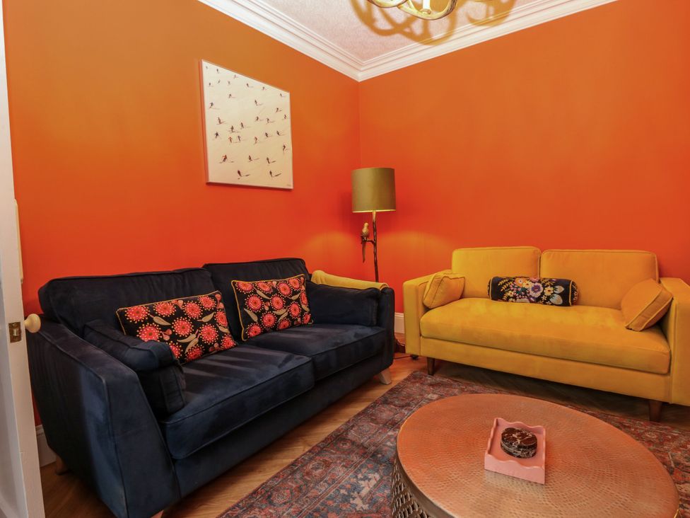 A living room with sofas and a table at Lindean in Ballater