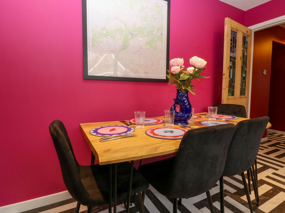 A dining room with a table set for meals at Lindean in Ballater