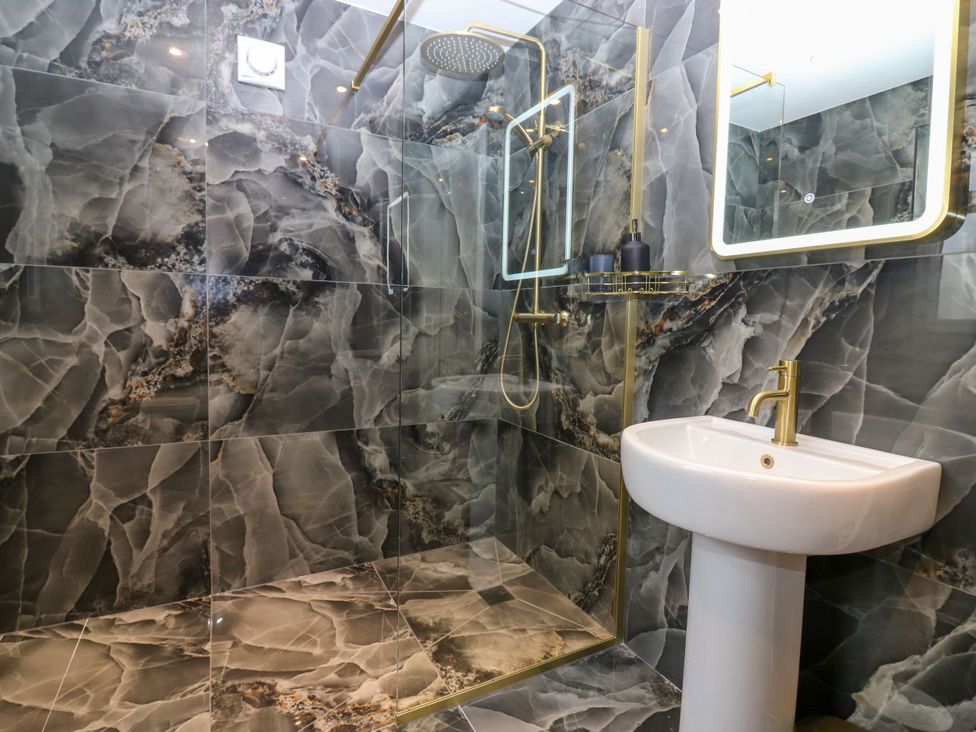A bathroom with a shower and sink at Lindean, Ballater