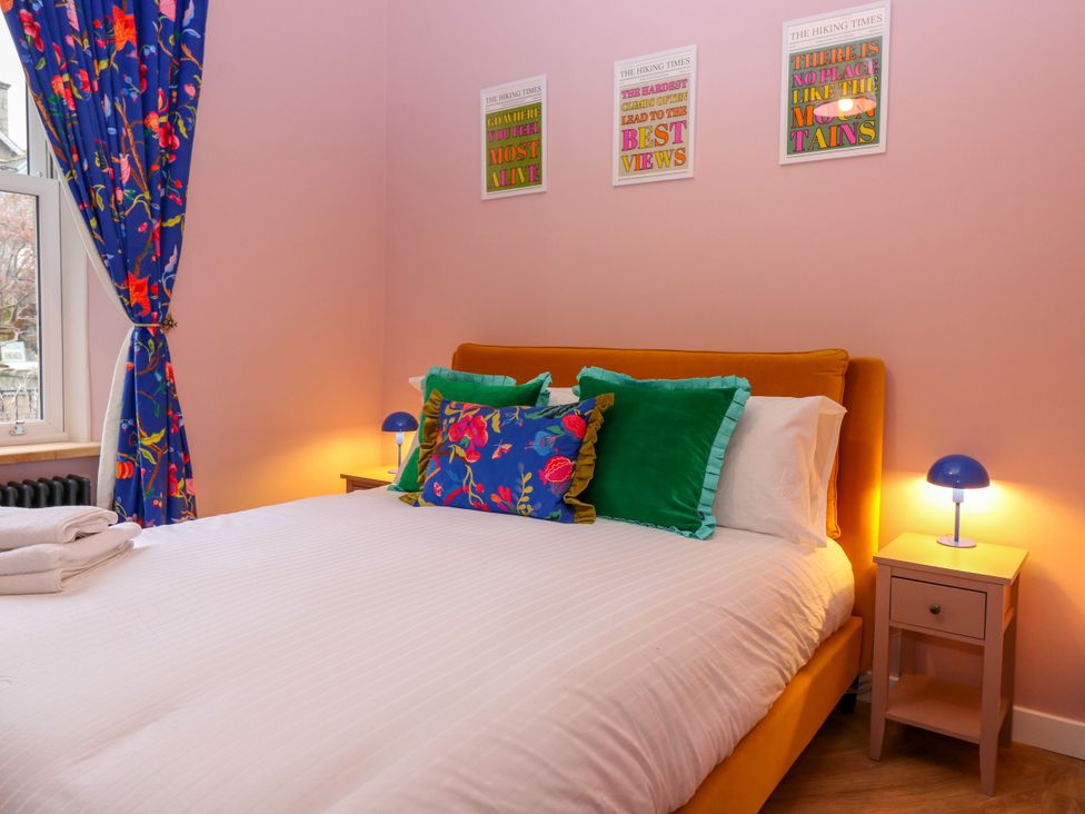 A bedroom with a bed and decorative pillows at Lindean in Ballater