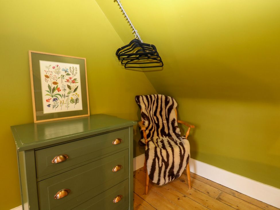 A chair with a blanket in an attic at Lindean in Ballater