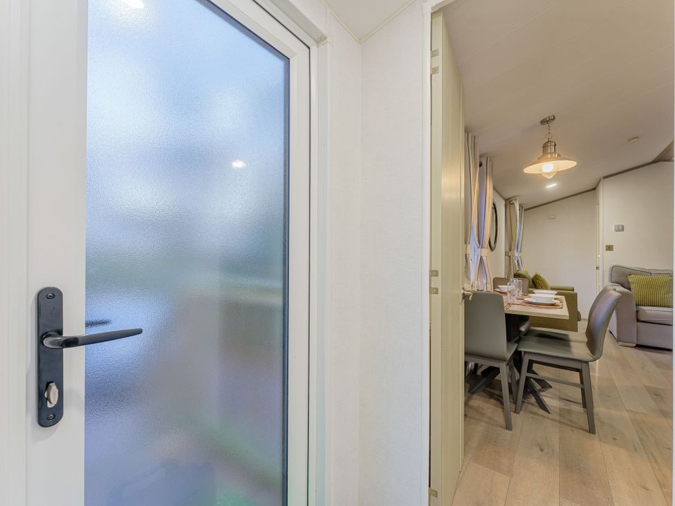 A dining room with a table and chairs visible through a door at Horncastle Spa Plus (Pet) in Louth