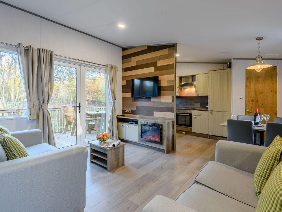 A living room with a television and sofa at Horncastle Spa Plus (Pet) in Louth