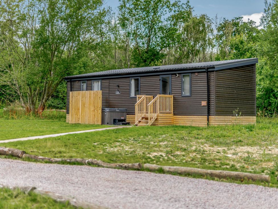 A cabin with a hot tub and pathway at Horncastle Spa Plus (Pet) in Louth