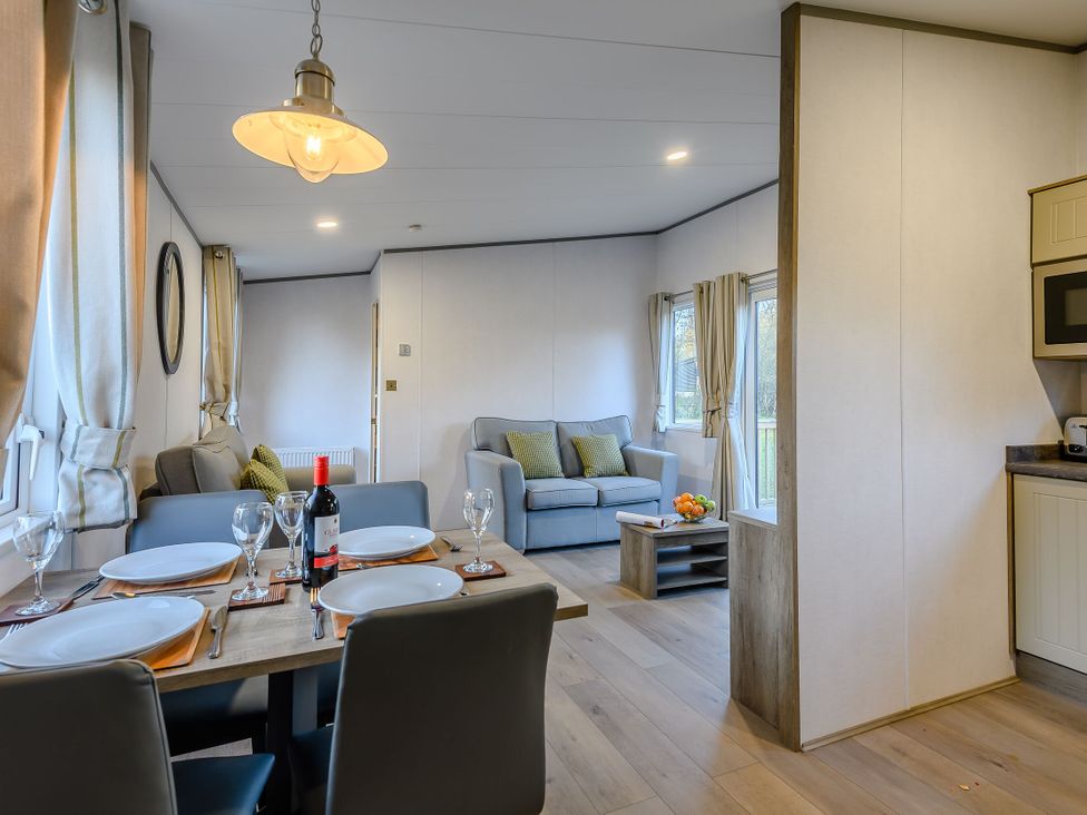 A dining room with a table set and a sofa at Horncastle Plus (Pet) in Louth